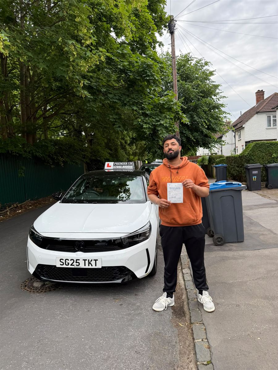 Learner with his DVSA pass certificate after a successful driving test